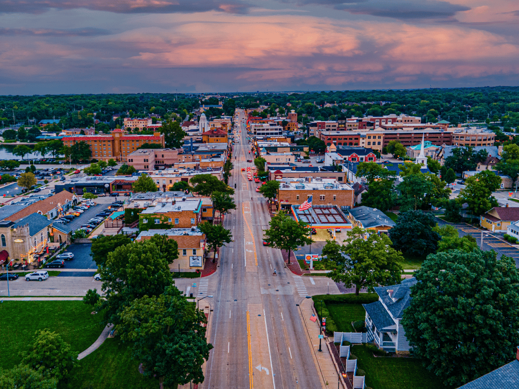 Aerial view of downtown St Charles Illinois along Main Street at sunset with shops, homes, and tree lined streets